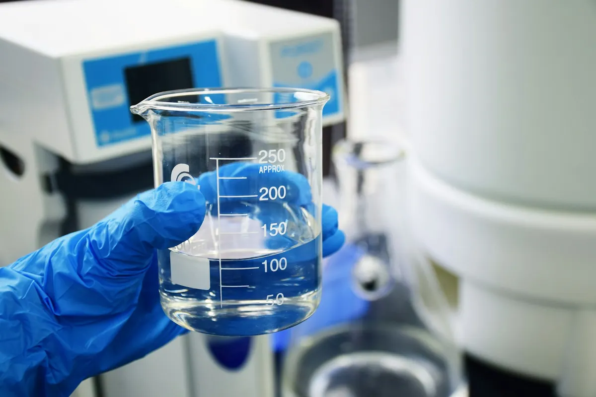 Laboratory glassware arranged on a light work surface